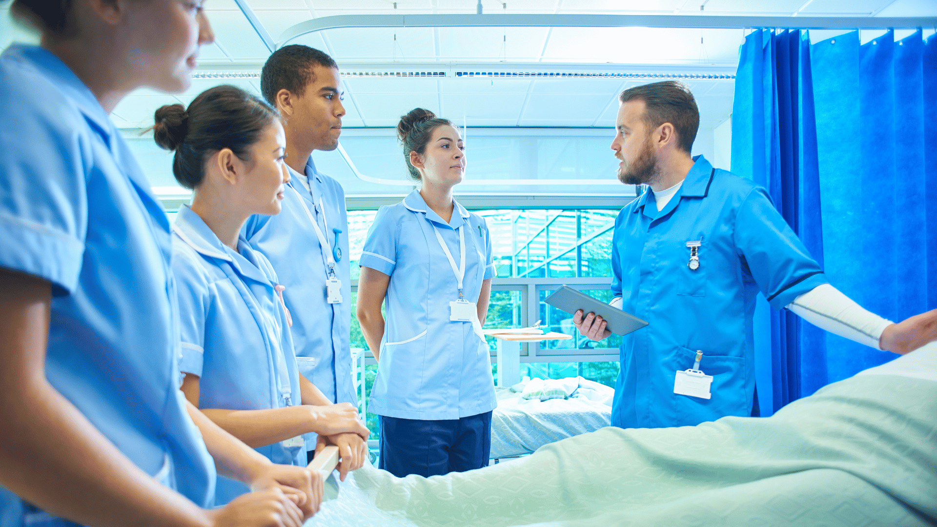 male nurse precepting students and explaining nursing specialties